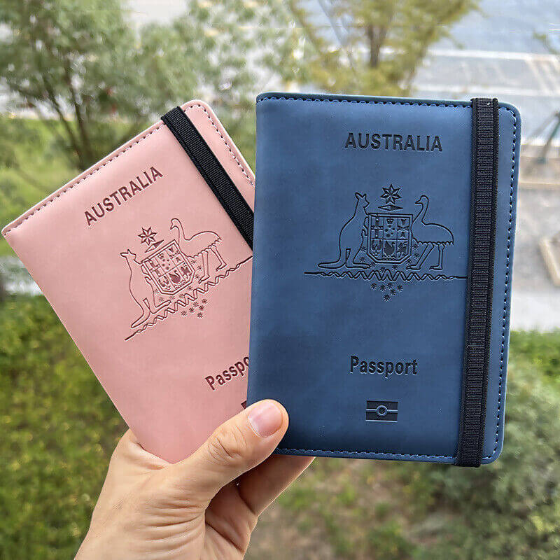 Hand holding one Pink & one Navy RFID Australia Passport Holder
